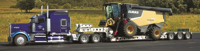 harvester hauling by Every Trucking